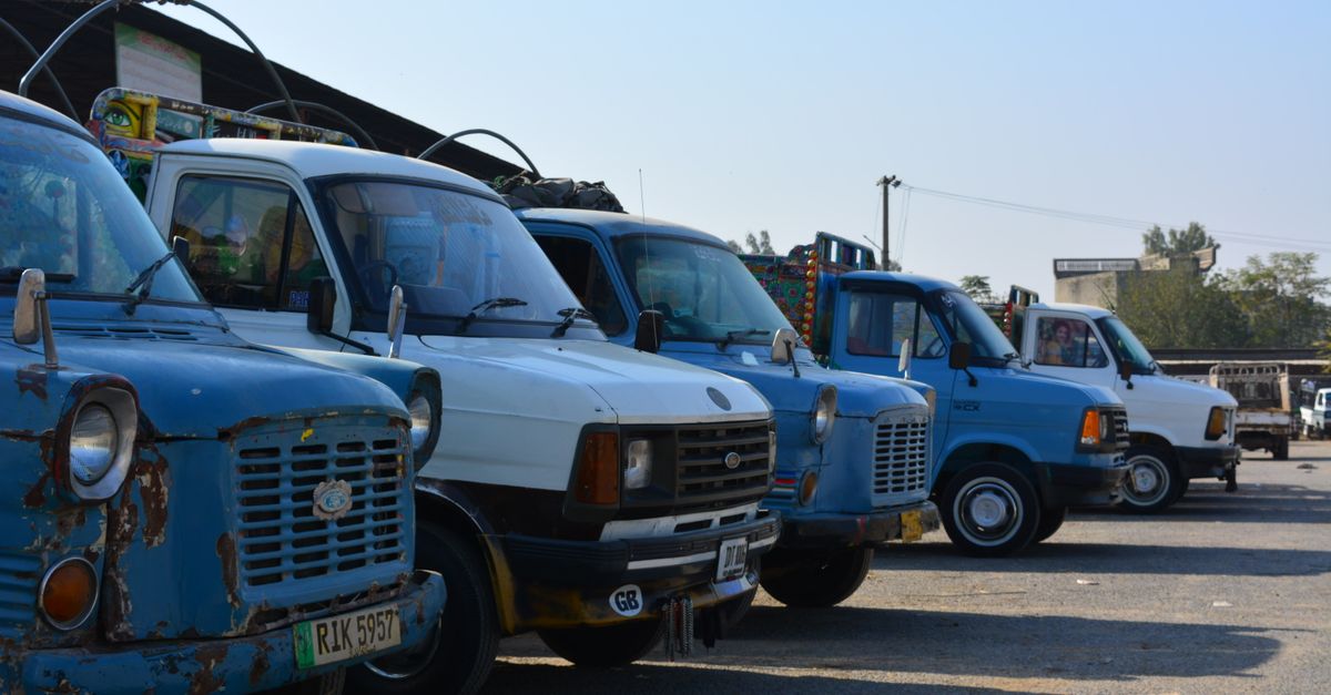 A collection of classic Ford vans parked in Taxila, showcasing vintage automotive design.